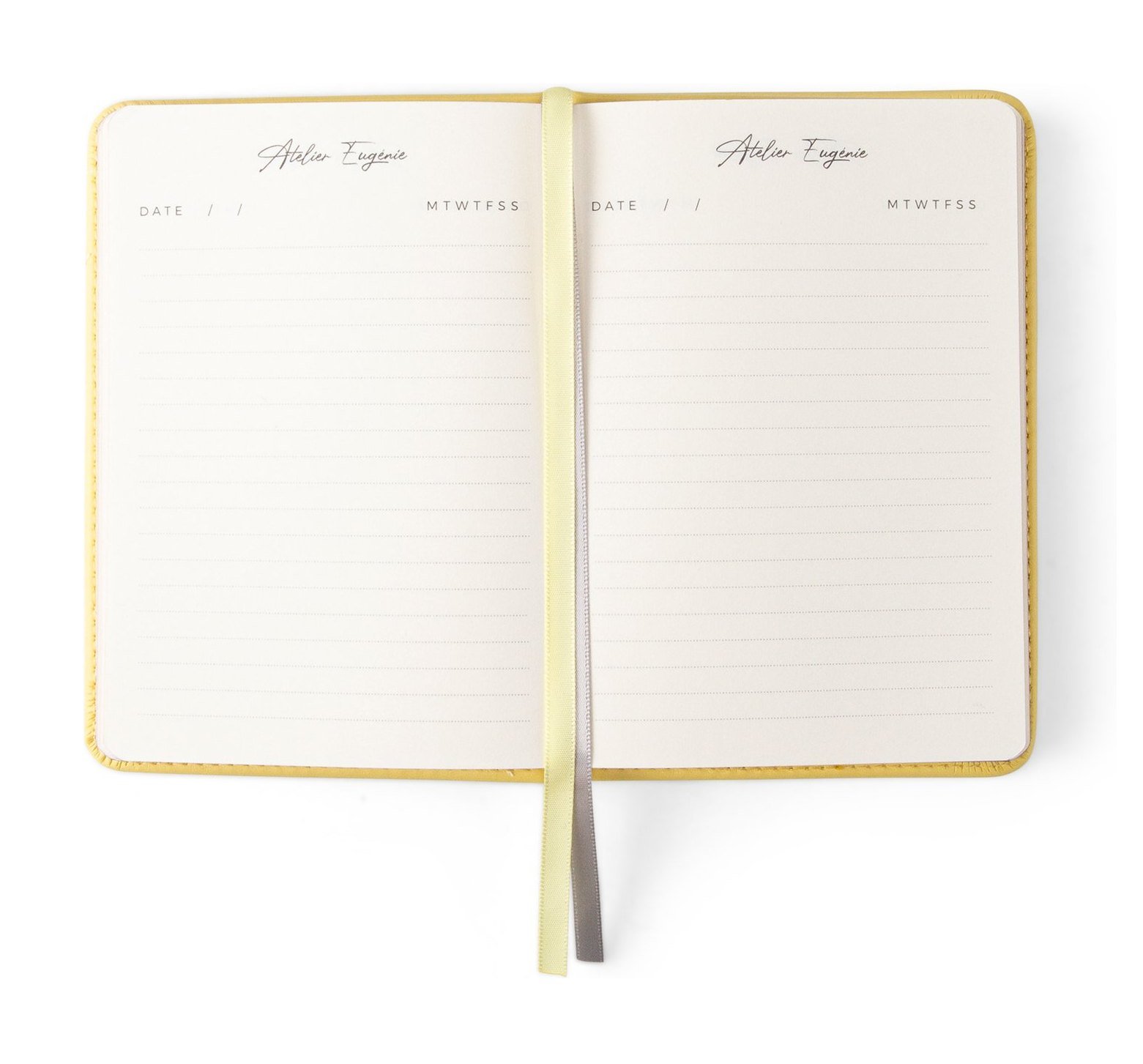 An open Notebook A6 in Jaune Poussin, lined pages and ribbons